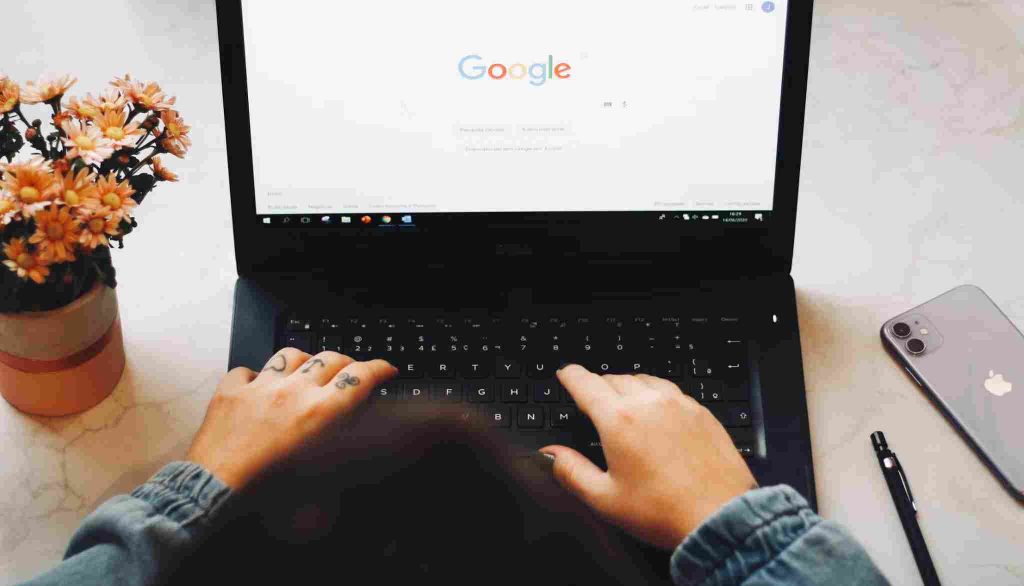 Person using laptop with Google search open for local business queries