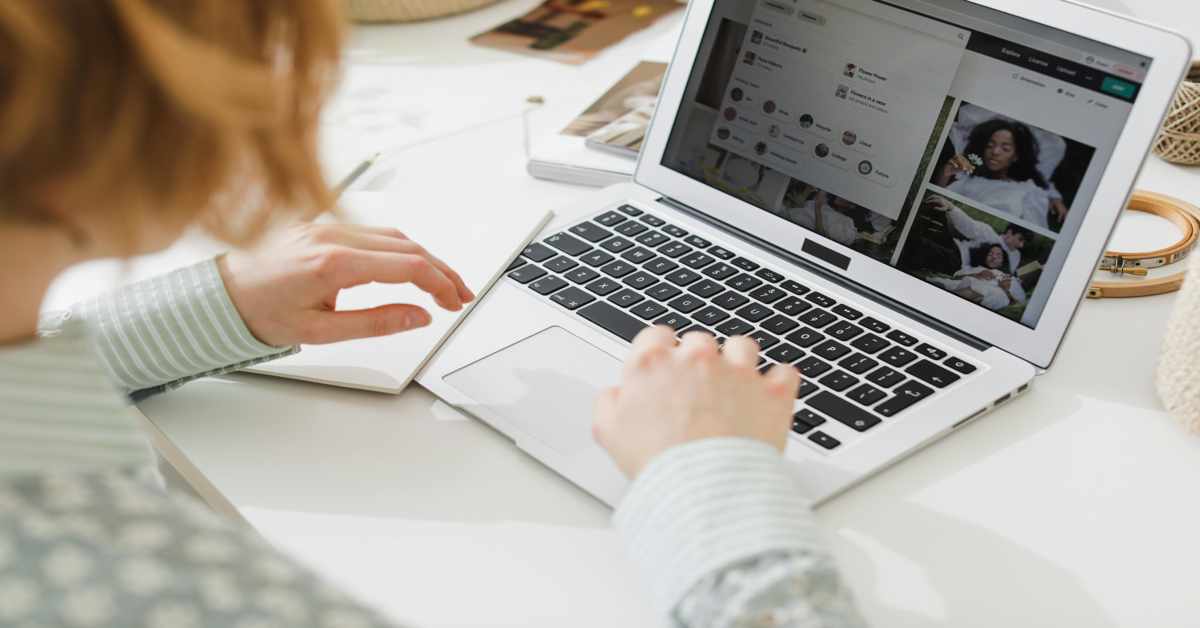 A marketer analyzing social media content on a laptop, representing brand safety and digital risk management.