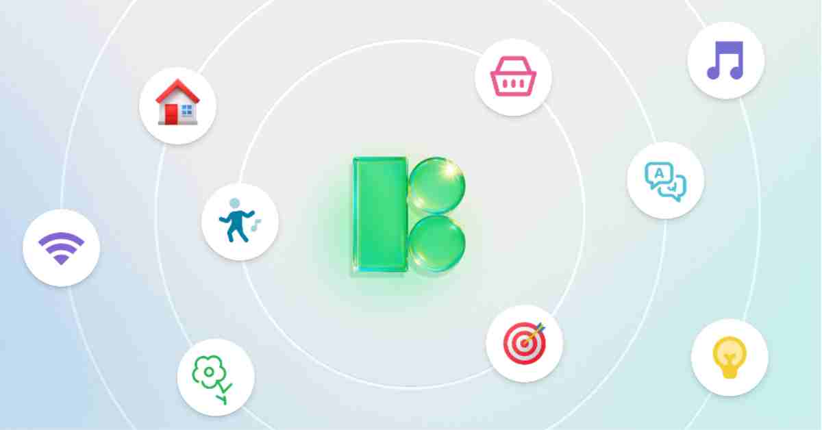 A designer working on UI icon systems using a laptop and tools on a clean workspace